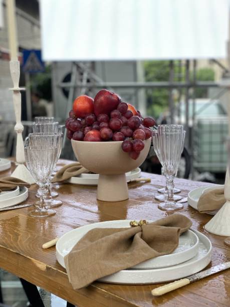 istock table setting outdoors, the table is set beautifully with glasses and vases, plates and so on 2155812378