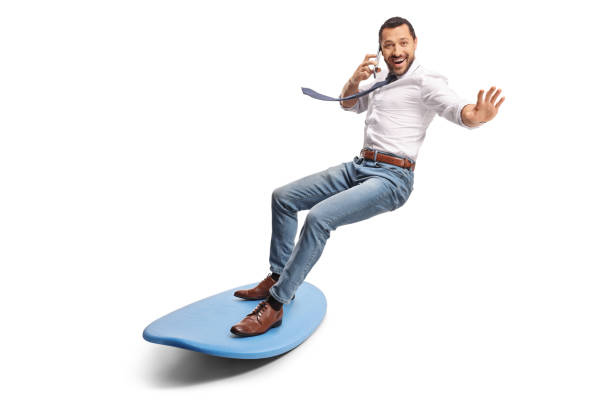 istock Man making a phone call and riding a surfboard 2155818427