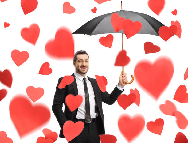 bearded man with a black umbrella and in a suit on a light background in full growth. High quality photo