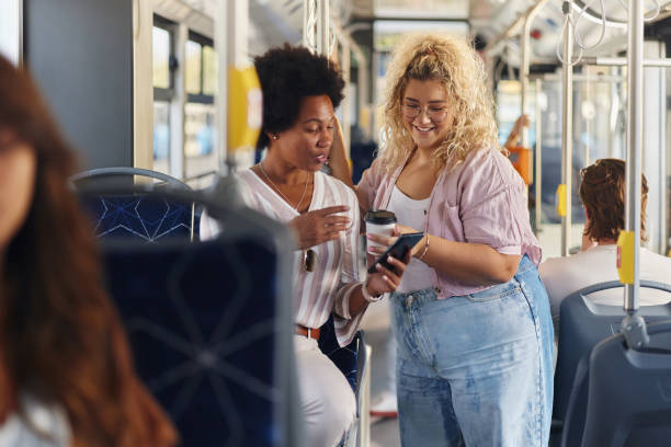 istock Happy diverse women using cell phone in a public transport. 2155819670