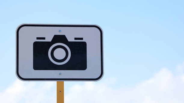 Road sign indicating fixed camera that photographs vehicles breaking the speed limit, or run red traffic lights