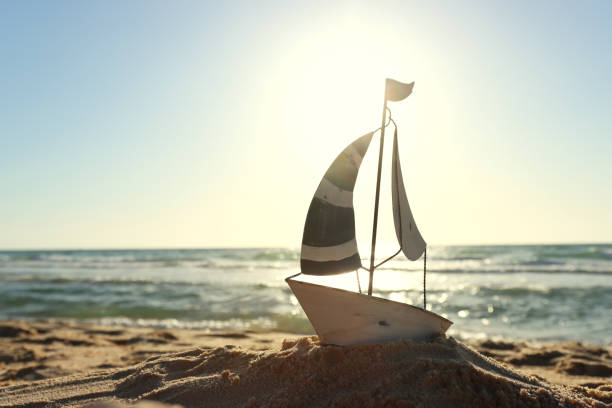 Small vintage boat on beach at summer sunset
