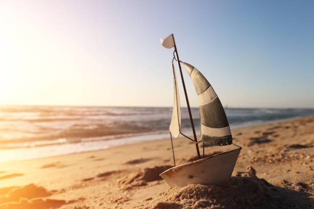 istock Small vintage boat on beach at summer sunset 2155821945