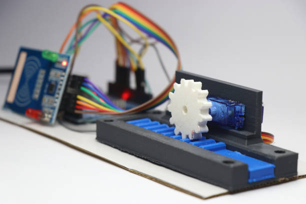 istock Mechatronics project demonstration with 3d printed gear and slider mechanism and micro controller on the background isolated on white 2155824021