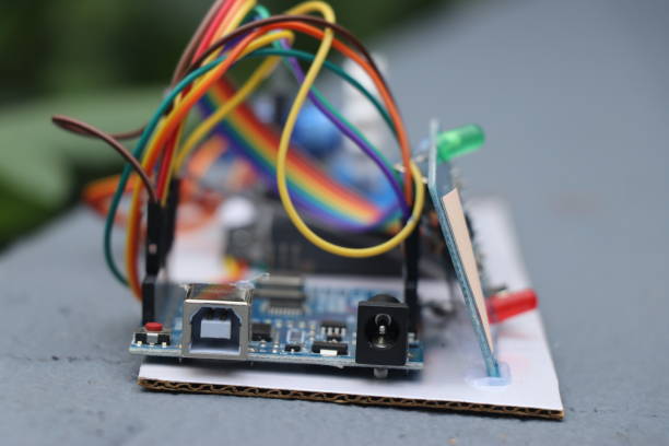 istock Prototype of some electronic project with jumper cables connecting to micro controller and LED with a natural light background 2155824286