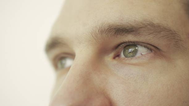 istock Young male eyes looking aside. Eye care, vision concept. Slow motion 2155826716