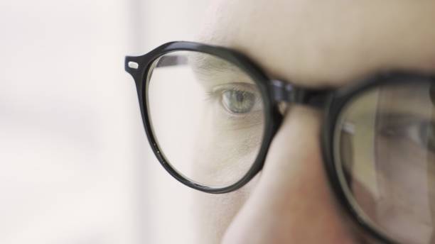 istock Man eyes in eyeglasses looking intently forward, isolated on white, Close up 2155826731