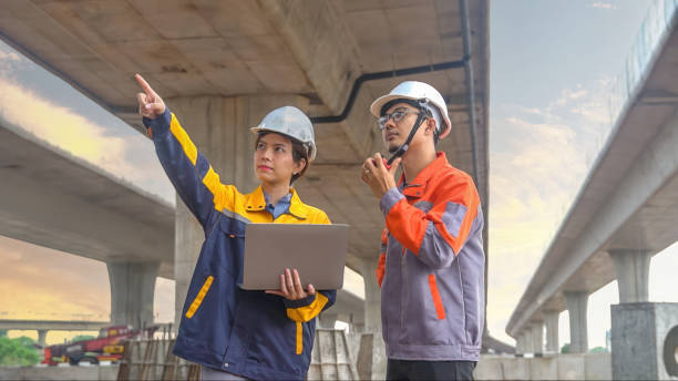 istock Asian male and female engineers Inspecting construction work radio command concrete road bridge highway 2155826838