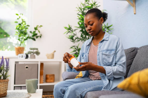 istock Young woman taking medicines 2155828319