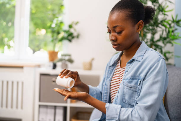 istock Young woman taking medicines 2155828322
