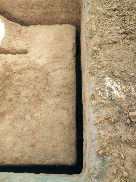 istock How to dig a deep narrow trench for a water pipe or electric cable? A simple hand tool for digging narrow trenches for communications. 2155830691