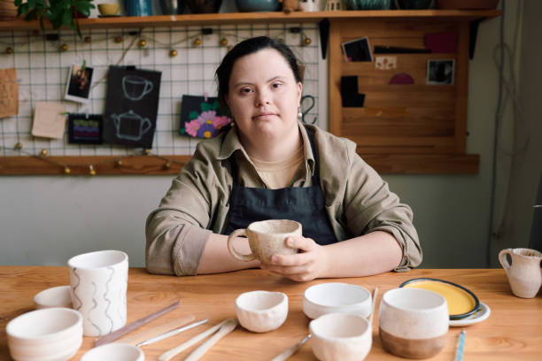 istock Young Woman With Disability Sitting At Table In Workshop 2155833619