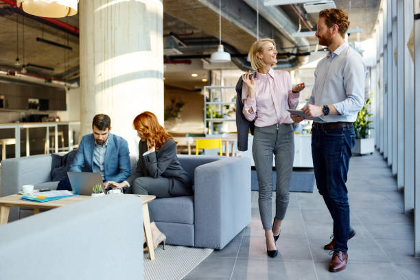 istock Business colleagues working on wireless technology in a hallway. 2155835080