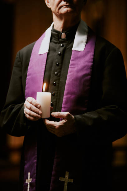 istock Pastor Holding Candle In Hands 2155836988