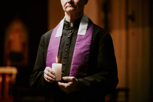 istock Elderly Pastor With Candle In Hands 2155837095