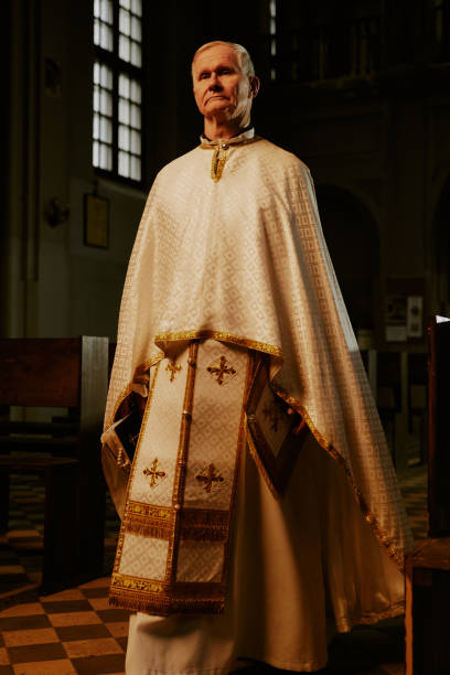 istock Priest Walking Along Church Nave 2155837632