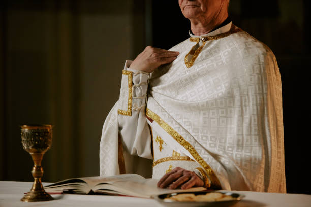 istock Senior Catholic Priest Praying 2155838626