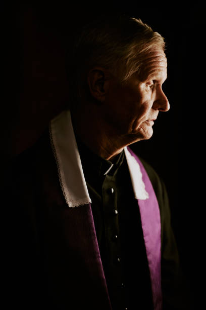 istock Senior Priest In Confessional Booth 2155838859