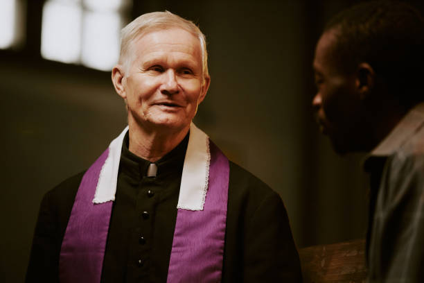 istock Catholic Priest Talking To Black Man 2155838900