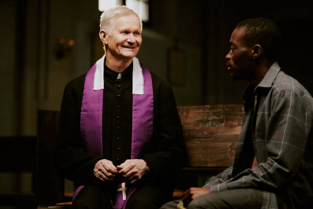 istock Cheerful Priest Talking To Black Man 2155838901
