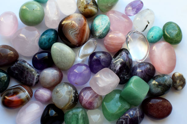 istock Beautiful natural semi-precious stones lie on a white background. Predictions, witchcraft, spiritual esoteric practice. 2155839499