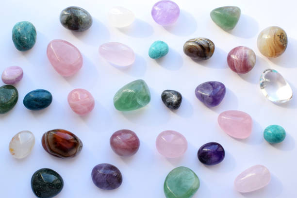 istock Beautiful natural semi-precious stones lie on a white background. Predictions, witchcraft, spiritual esoteric practice. 2155839505