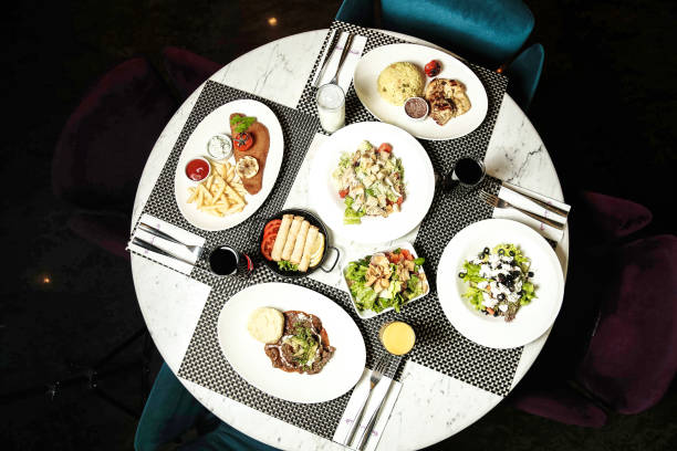 A white table displays an assortment of dishes filled with delicious food.