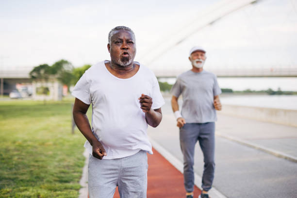 istock Two senior friends training together outside. Diverse Senior Man . 2155843226