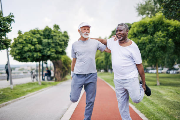 istock Two senior friends training together outside. Diverse Senior Man . 2155845192