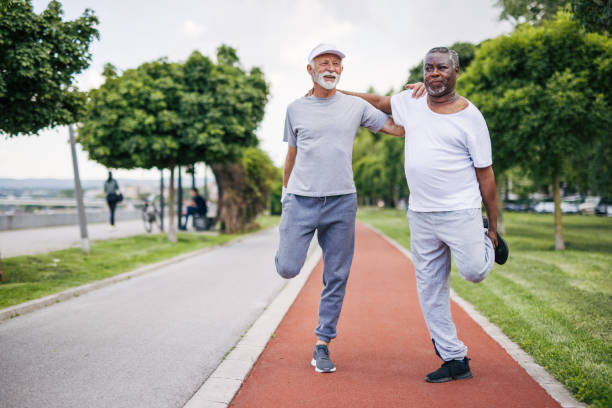 istock Two senior friends training together outside. Diverse Senior Man . 2155845231