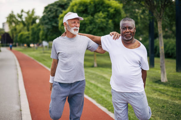 istock Two senior friends training together outside. Diverse Senior Man . 2155845307