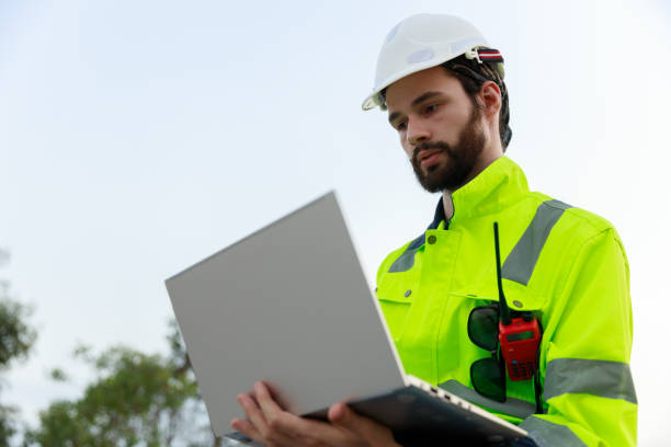 istock Engineer wearing safety uniform holding laptop discussed plan about renewable energy at station energy power wind. technology protect environment reduce global warming problems. 2155845528