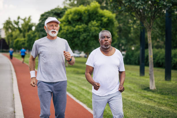 istock Two senior friends training together outside. Diverse Senior Man . 2155845542