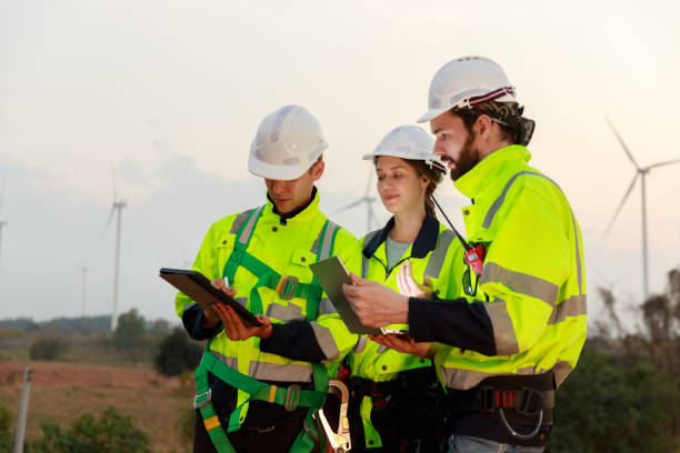 istock Engineer wearing safety uniform using tablet discussed plan about renewable energy at station energy power wind turbine. technology protect environment reduce global warming problems. 2155845552