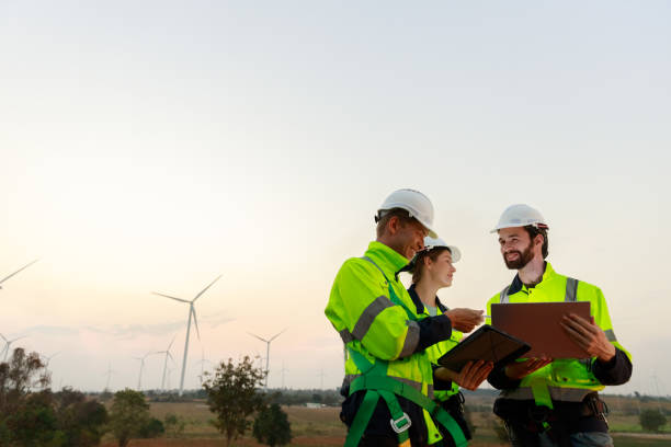 istock Engineer wearing safety uniform using tablet discussed plan about renewable energy at station energy power wind turbine. technology protect environment reduce global warming problems. 2155845559