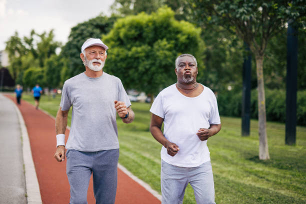 istock Two senior friends training together outside. Diverse Senior Man . 2155845595