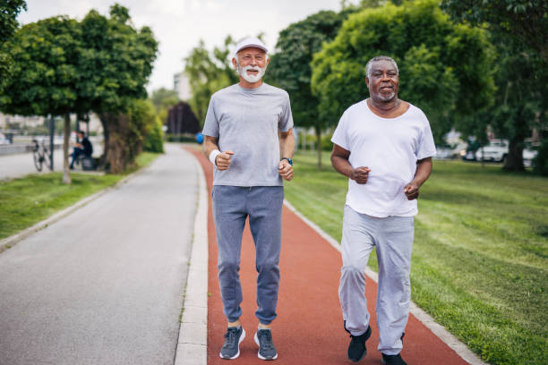 istock Two senior friends training together outside. Diverse Senior Man . 2155846201