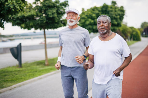 istock Two senior friends training together outside. Diverse Senior Man . 2155846348
