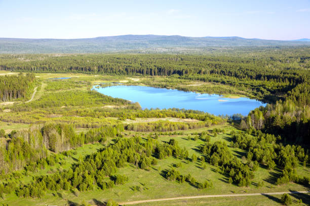 istock Blue lake in the summer forest between the mountains. View from above 2155846422
