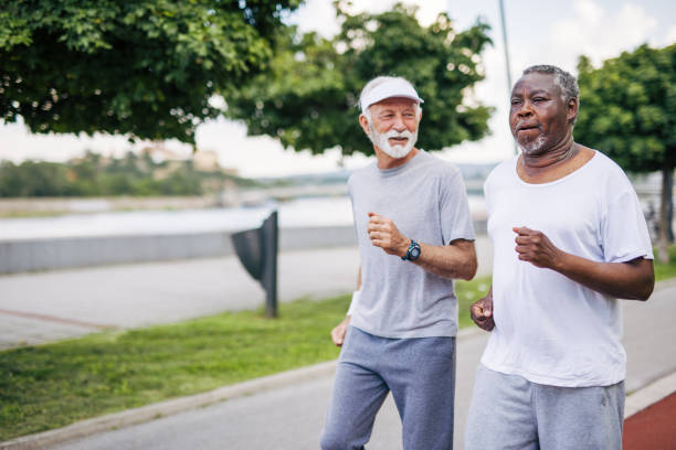 istock Two senior friends training together outside. Diverse Senior Man . 2155846442