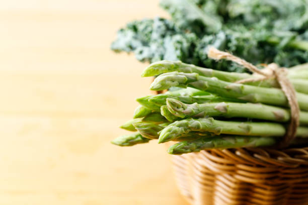 istock Fresh green asparagus bunch on wooden table. 2155846605