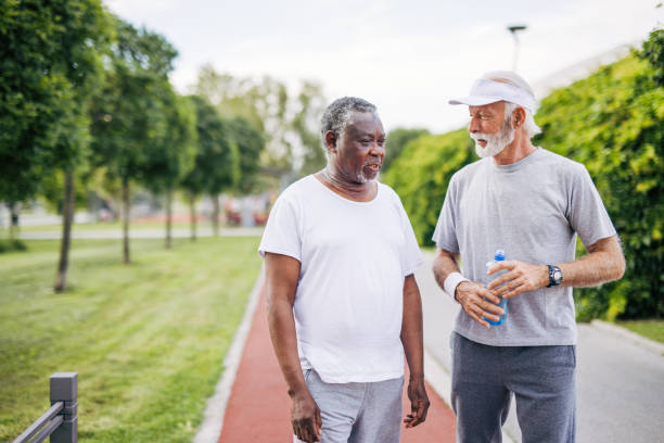 istock Two senior friends training together outside. Diverse Senior Man . 2155846661
