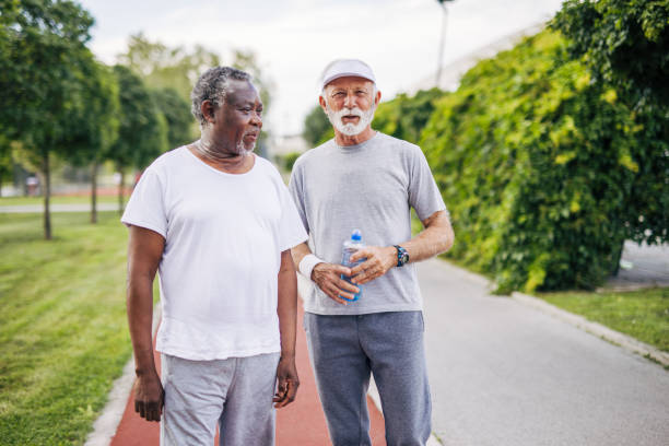 istock Two senior friends training together outside. Diverse Senior Man . 2155846732