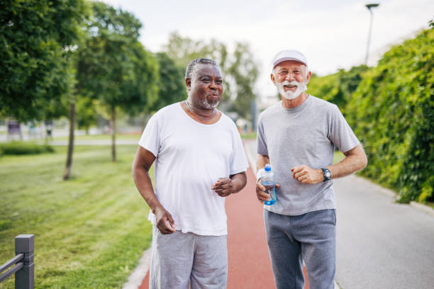 istock Two senior friends training together outside. Diverse Senior Man . 2155847009