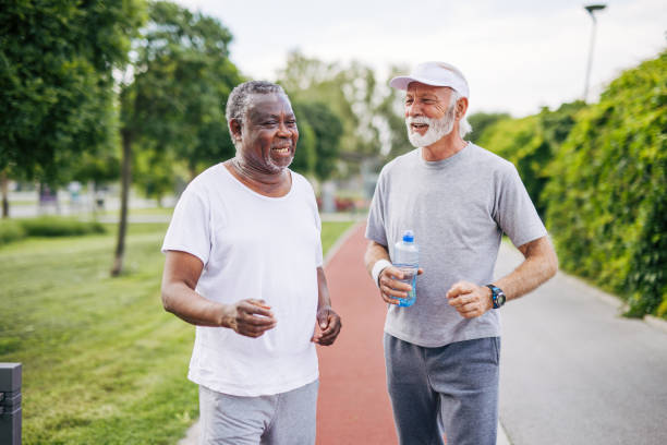 istock Two senior friends training together outside. Diverse Senior Man . 2155847010