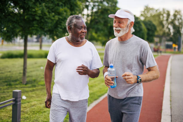 istock Two senior friends training together outside. Diverse Senior Man . 2155847046