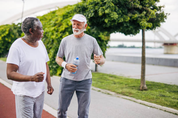 istock Two senior friends training together outside. Diverse Senior Man . 2155847173