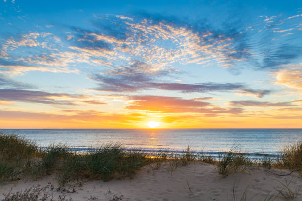 istock O'Sullivan Beach with clouds over the sea at sunset 2155847270