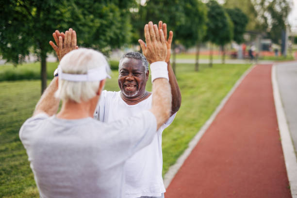 istock Two senior friends training together outside. Diverse Senior Man . 2155847592