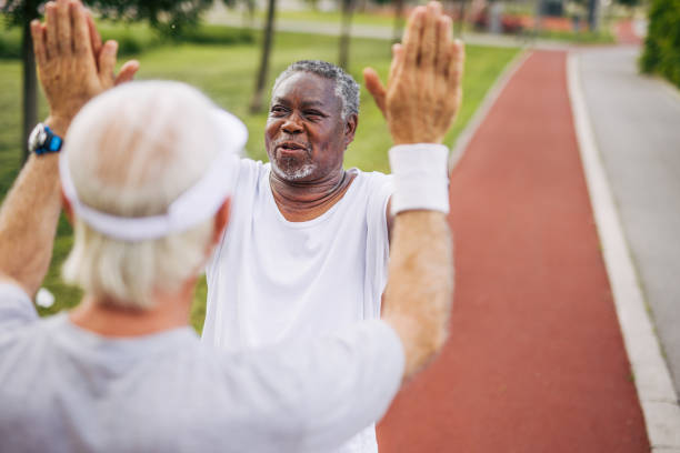 istock Two senior friends training together outside. Diverse Senior Man . 2155847637
